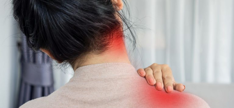 The back of a woman's head and shoulders, with red spots indicating pain on the side of her neck and top of her shoulder.