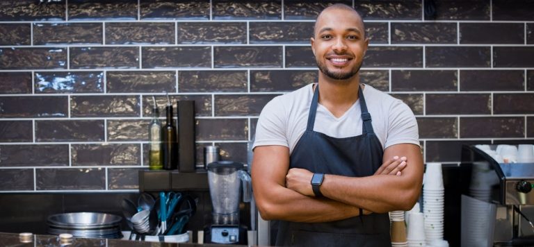 A small business owner standing in his kitchen.